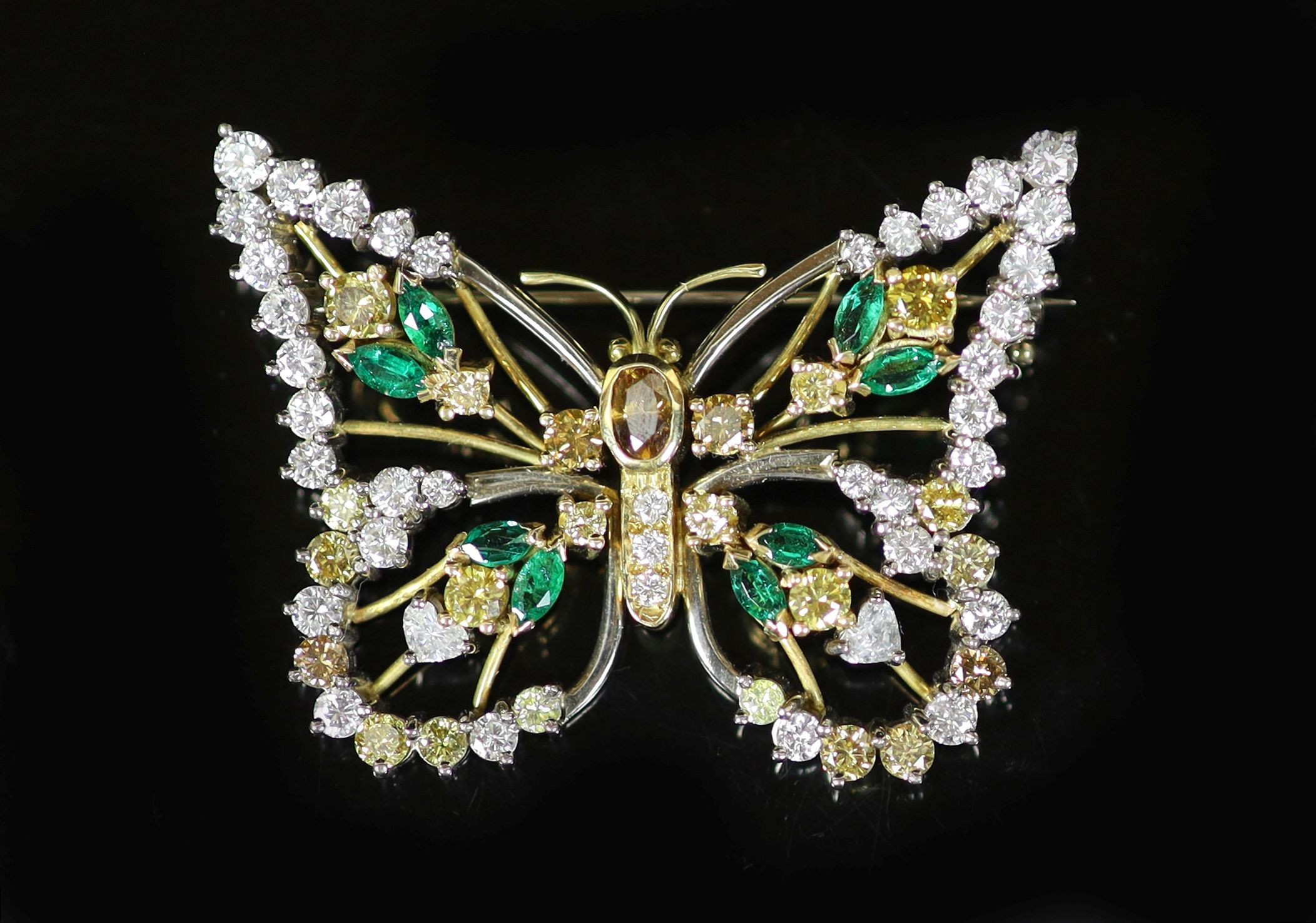 A modern white and yellow gold, diamond, emerald and citrine set open work butterfly brooch